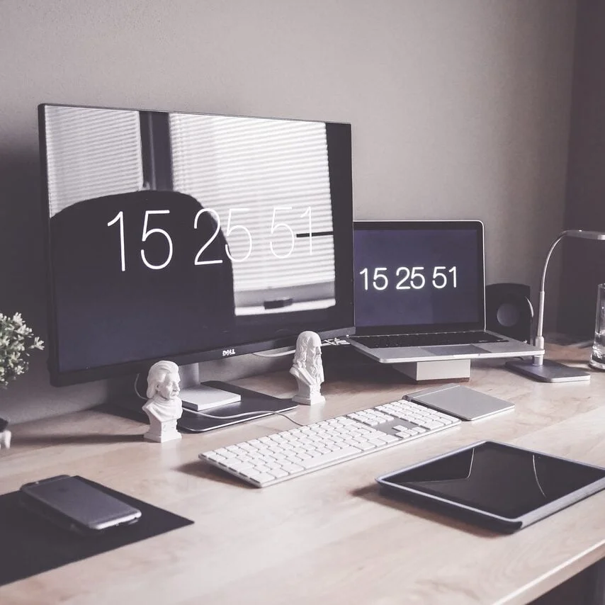 Computers on desk with time displays